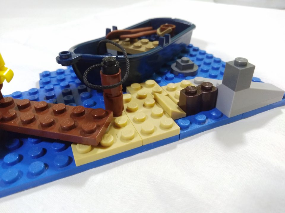 A LEGO Pirate boat moored to a dock