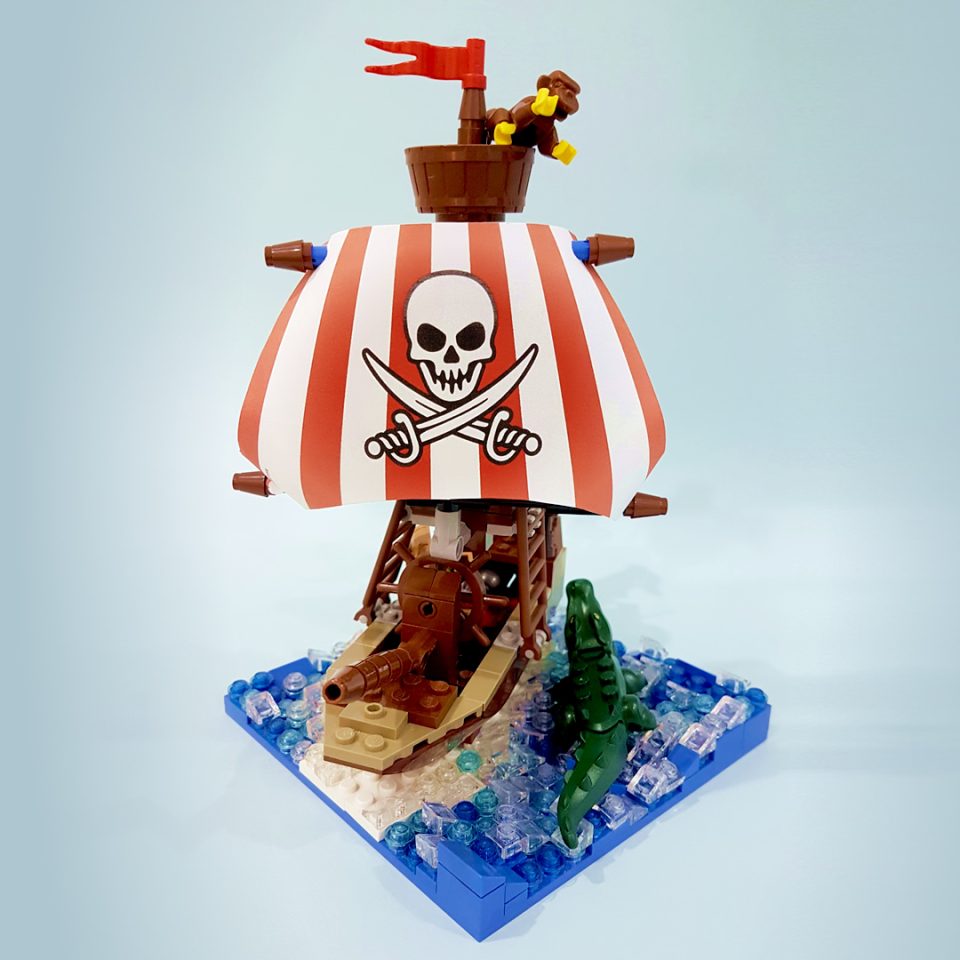 Bow of ship with front view of sail with Jolly Roger