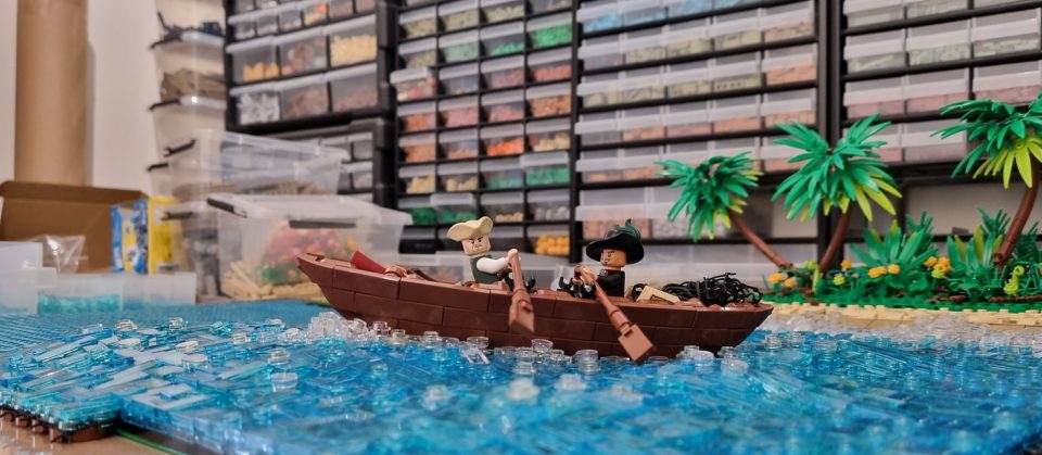 LEGO boat on LEGO sea with LEGO palm trees