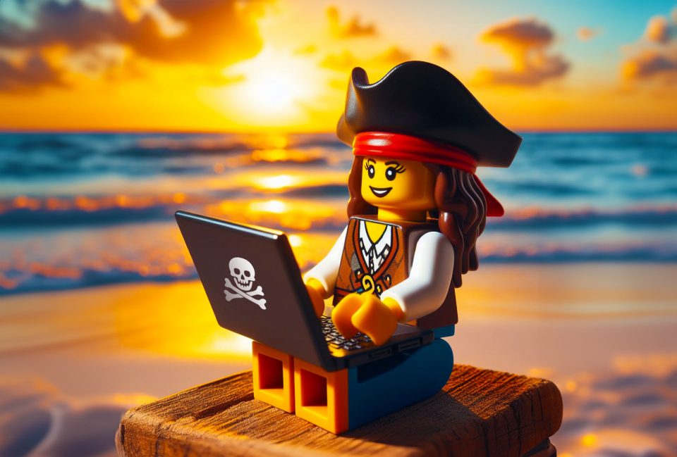 LEGO Pirate using laptop on beach at sunset