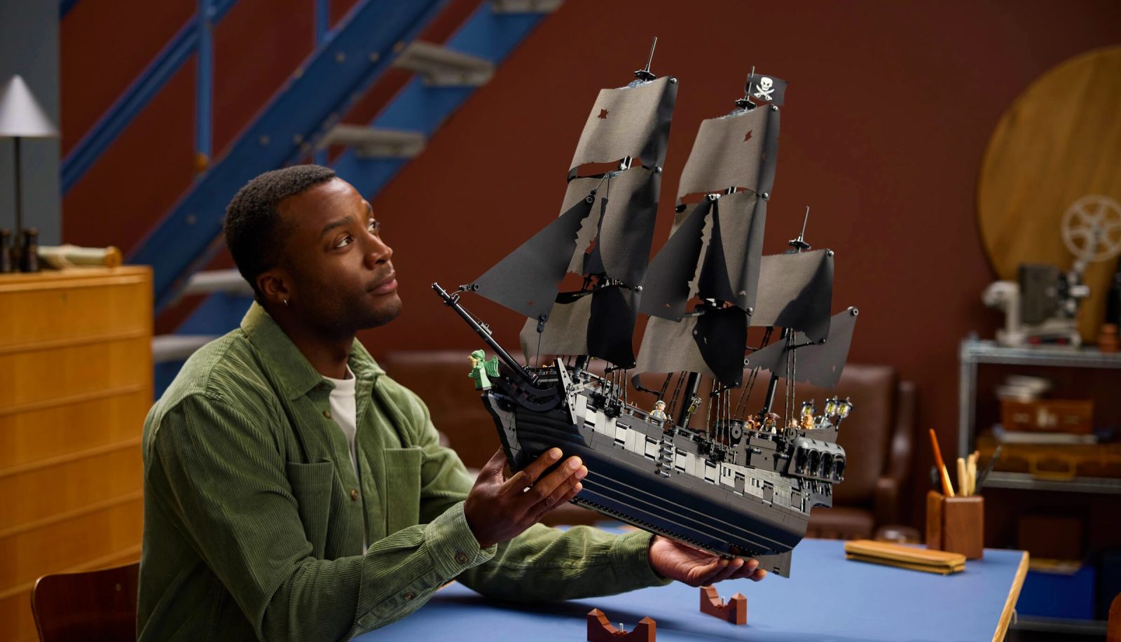 Man holding 10365 Jack Sparrow's Pirate Ship