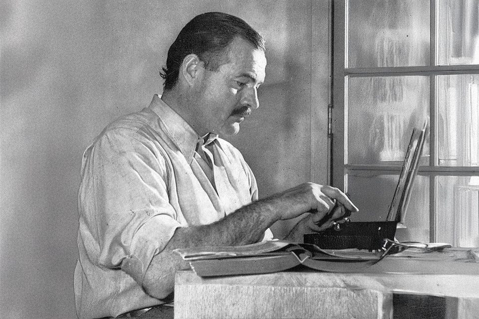 Click here to enlarge image Ernest Hemingway writing on his laptop