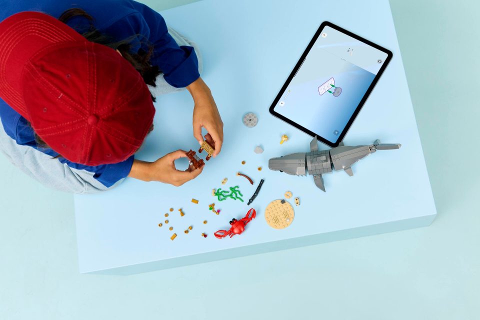Click here to enlarge image Child using LEGO Builder Mobile App to construct 31381 Fierce Shark with a Treasure Chest