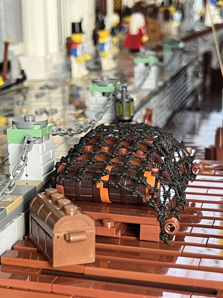 Click here to enlarge image Treasure an cargo on the docks of Port Royal